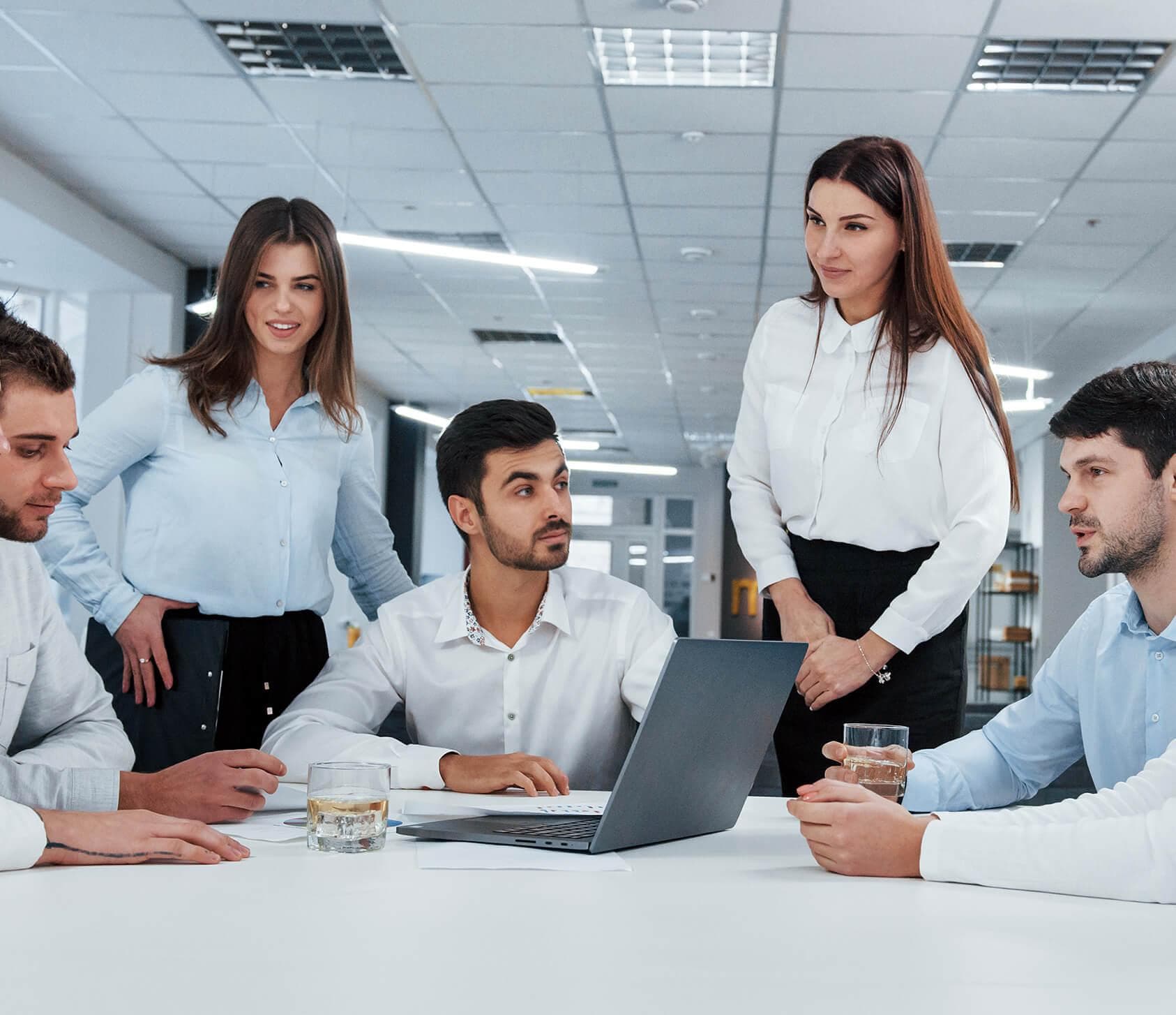 An American Tax Savings advisor reviewing a client's records at a conference table.